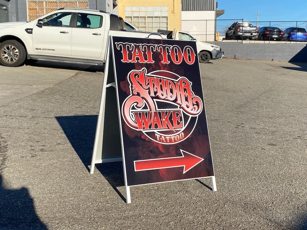 A Sign For A Tattoo Shop With An Arrow Pointing To The Right — Capital Signs in Canberra, ACT