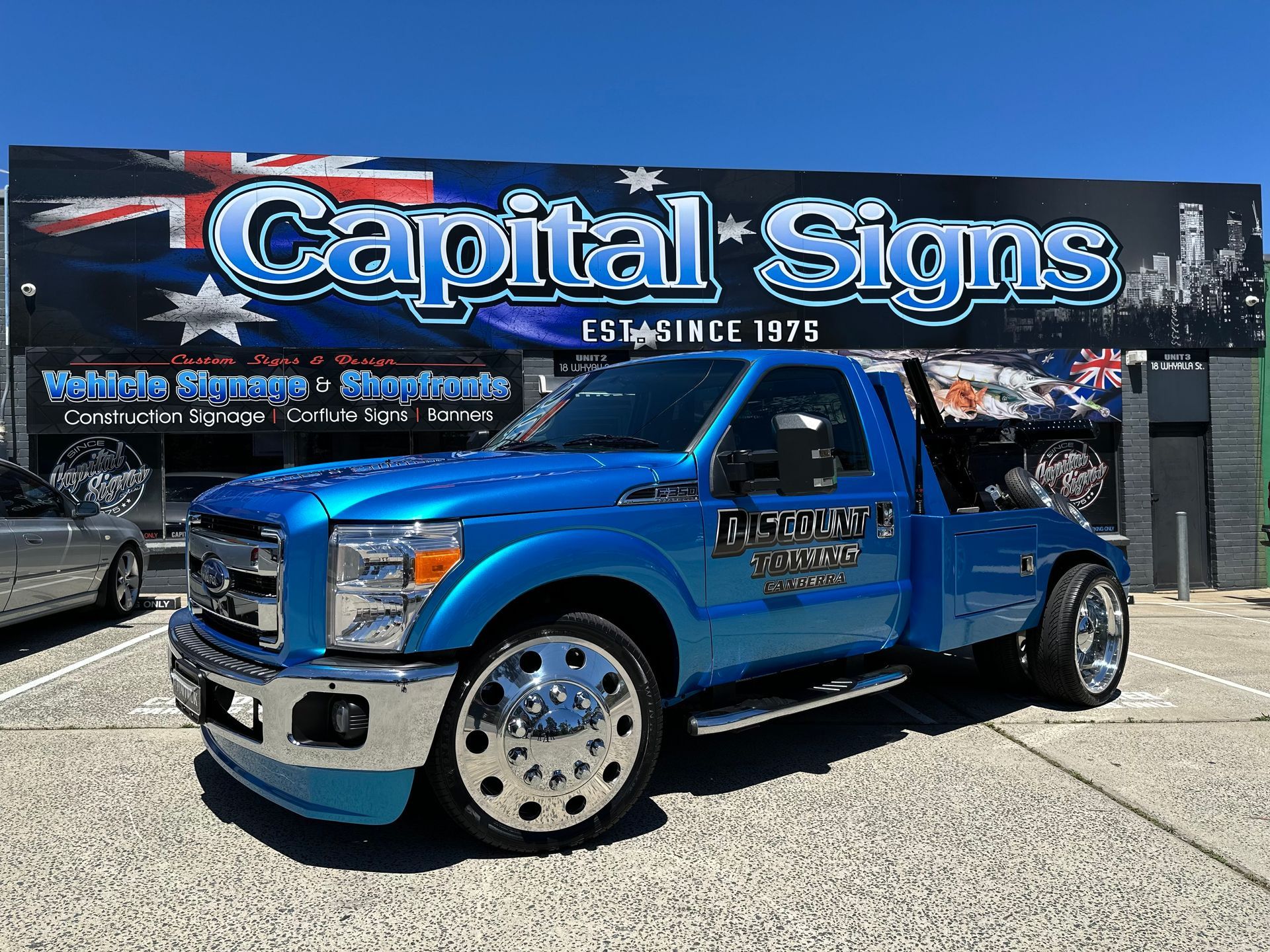 Blue tow truck with chrome wheels in front of a Capital Signs building — Capital Signs in Fyshwick, ACT