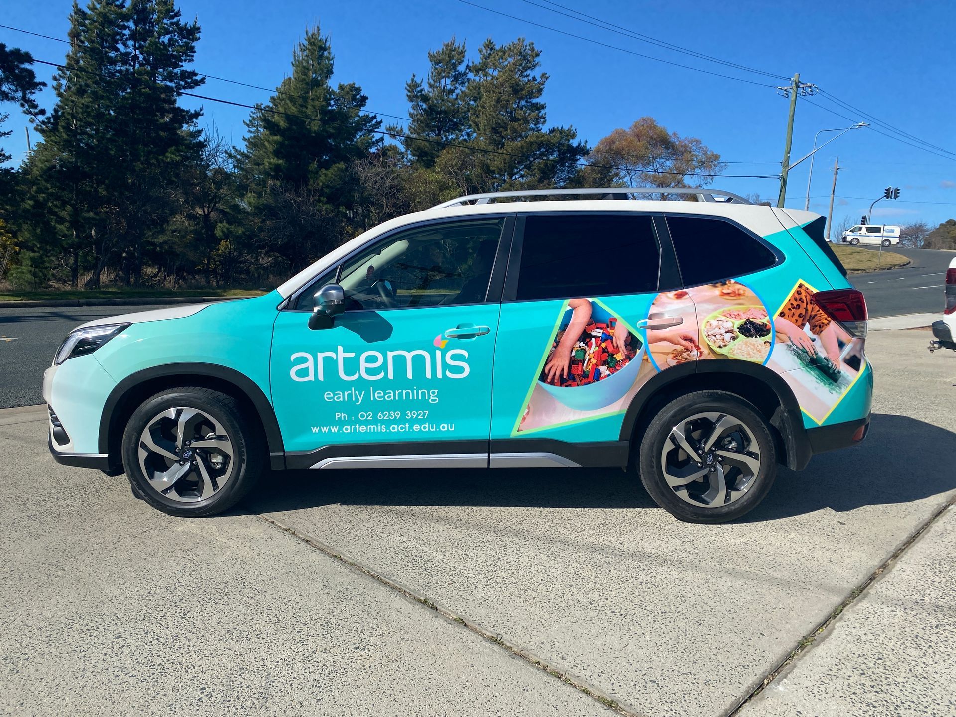 A Blue Car Is Parked On The Side Of The Road — Capital Signs in Fyshwick, ACT