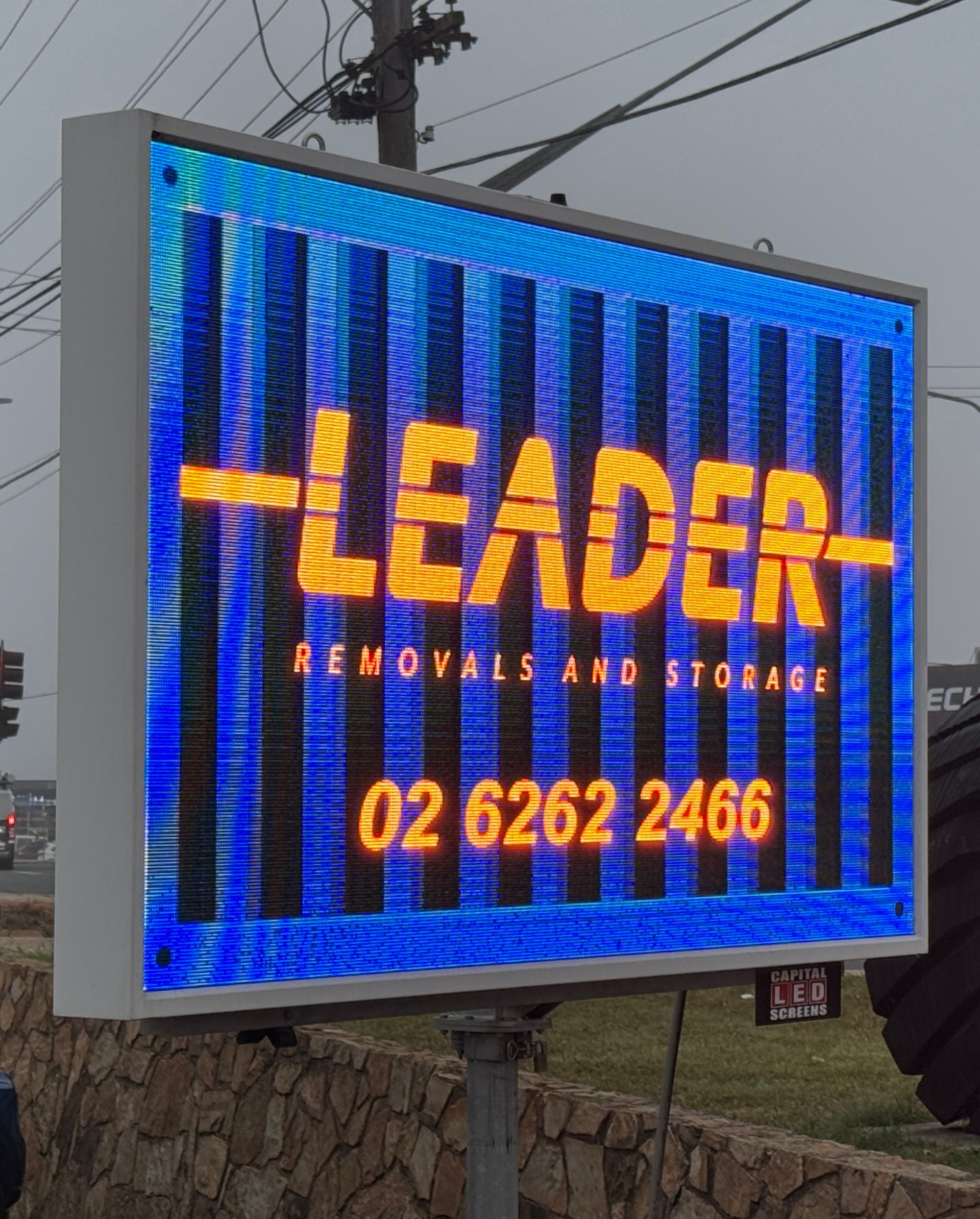 LED sign for Leader Removals and Storage with logo, phone number, and blue and orange color scheme — Capital Signs in Fyshwick, ACT