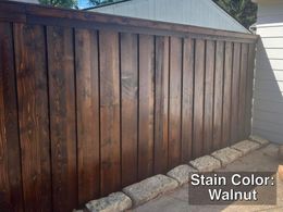 Dark brown walnut stained wooden fence.