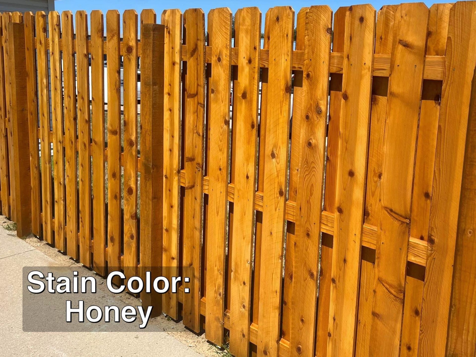 Wooden fence stained honey color.