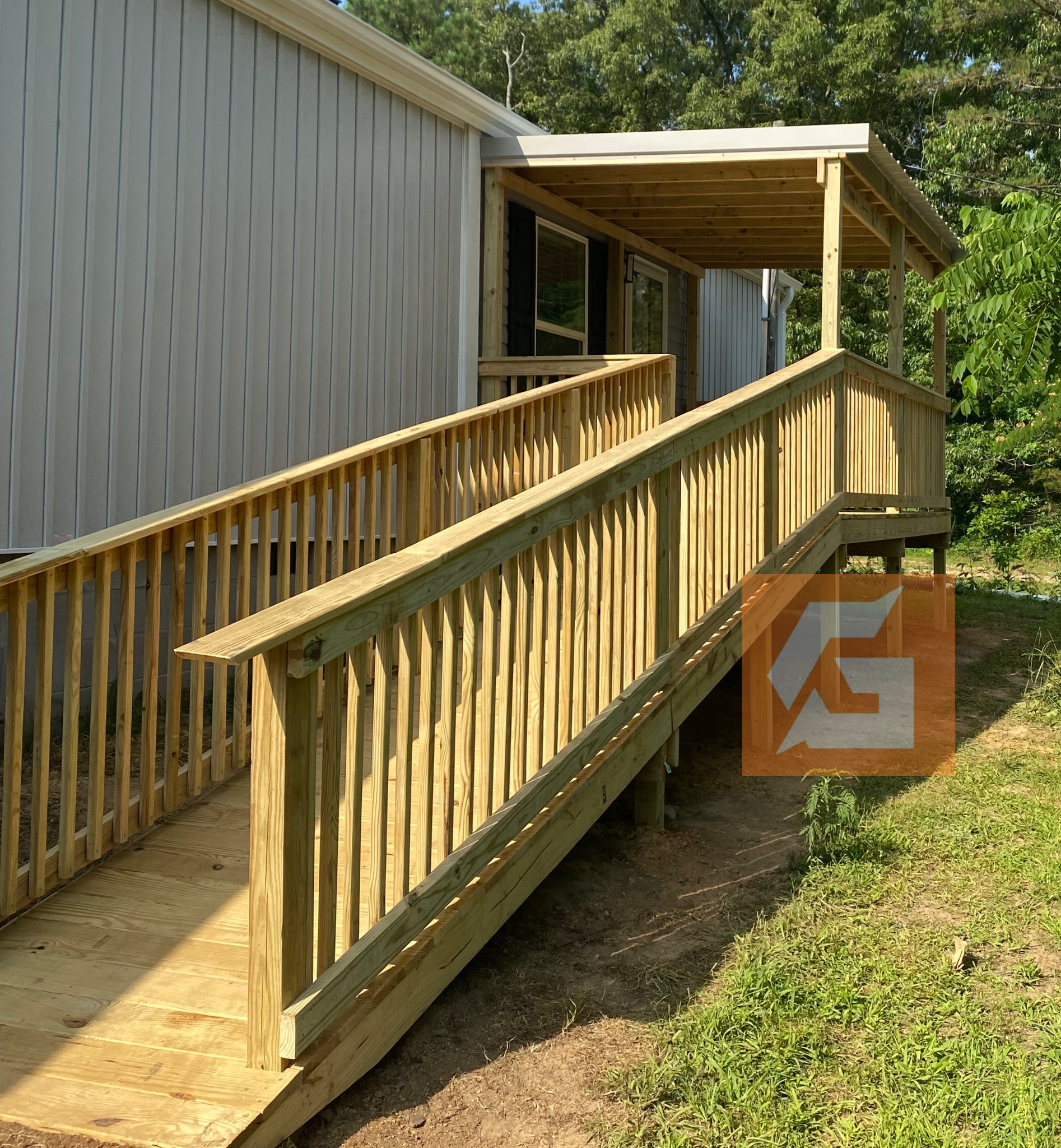 Wooden ramp with handrails leading to a covered porch of a building.