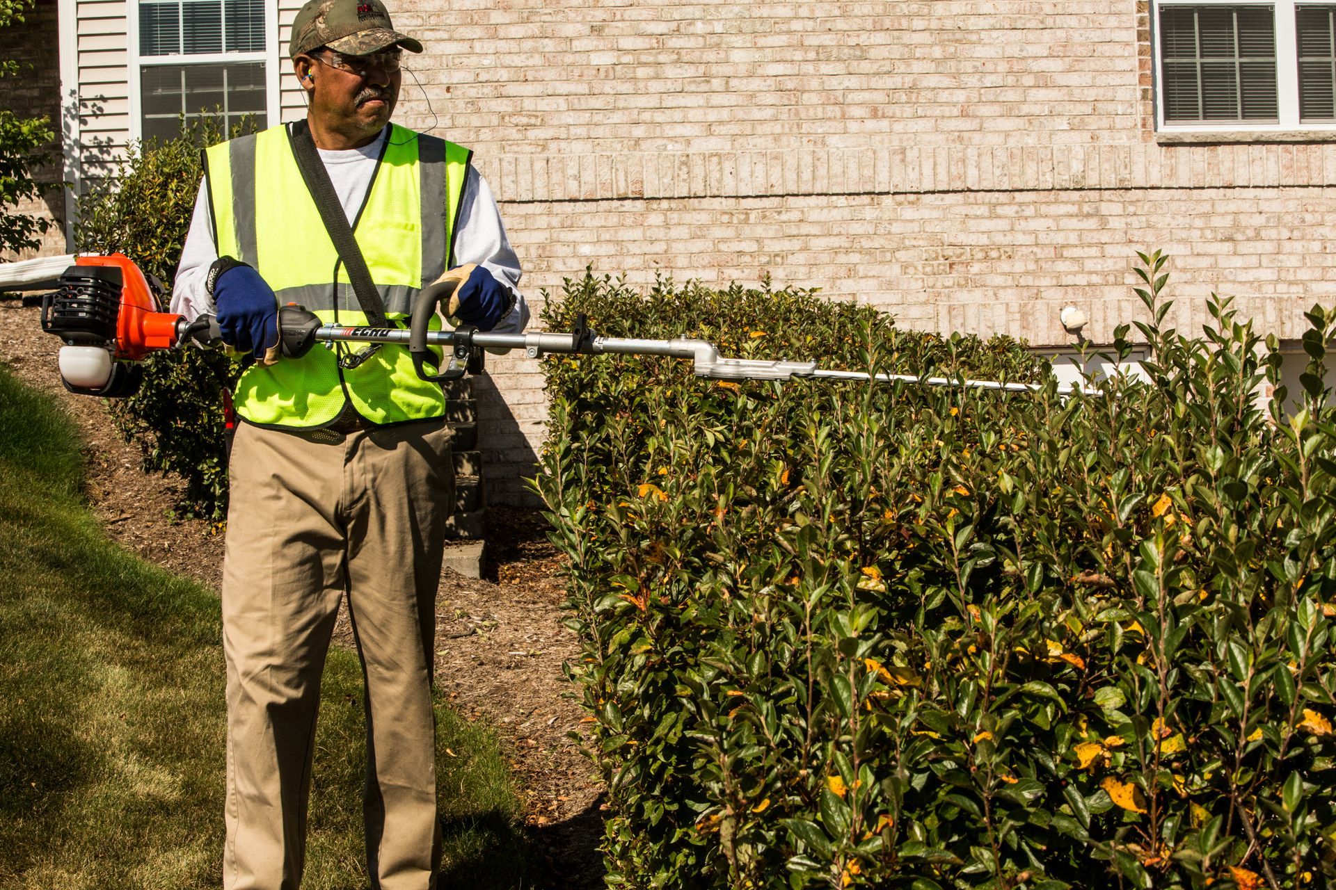 Man using Echo Hedge Trimmer Attachment