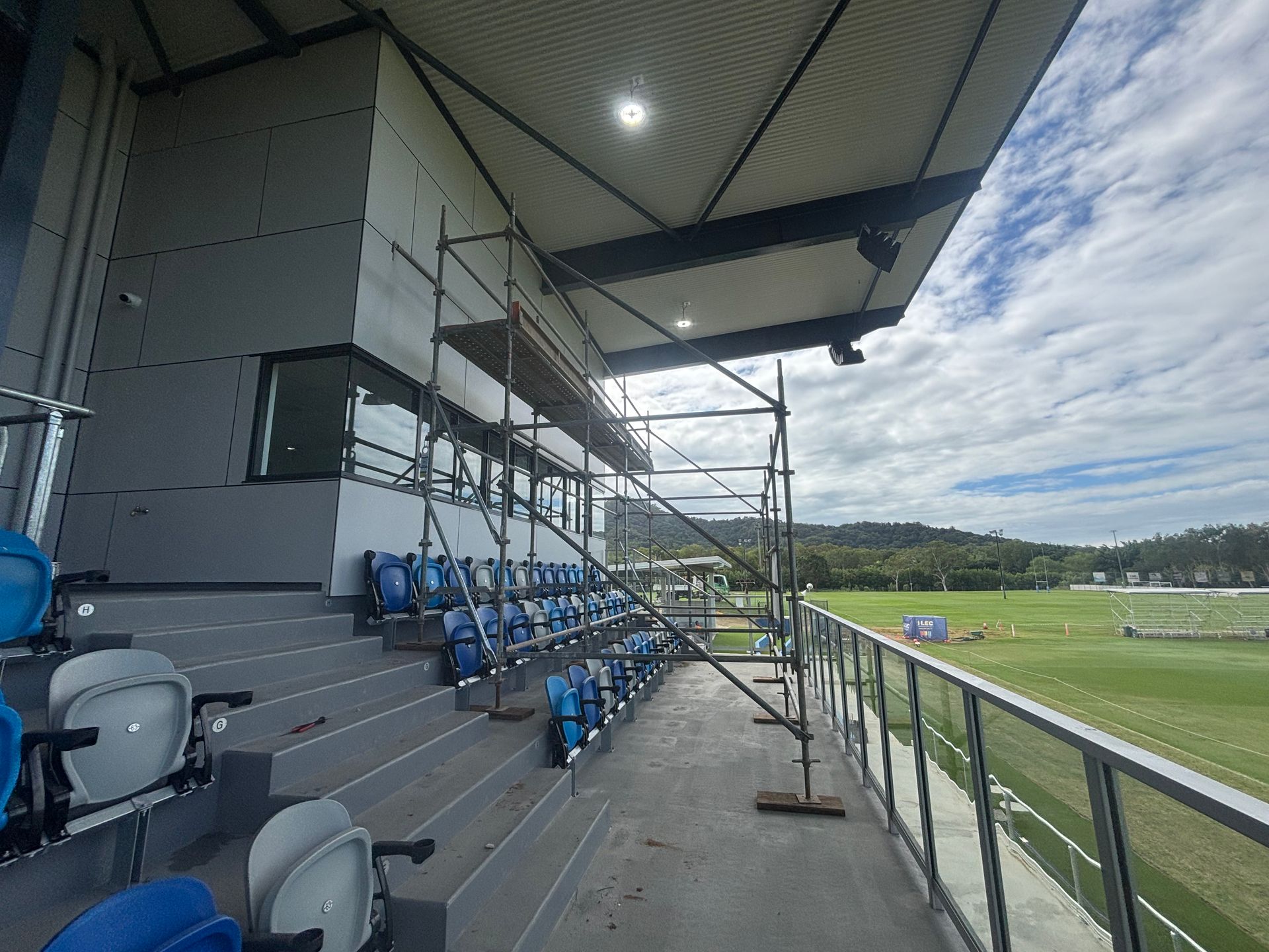 Scaffolding With a Yellow Hard Hat Visible in the Background — Underdog Edge Protection in Redlynch, QLD