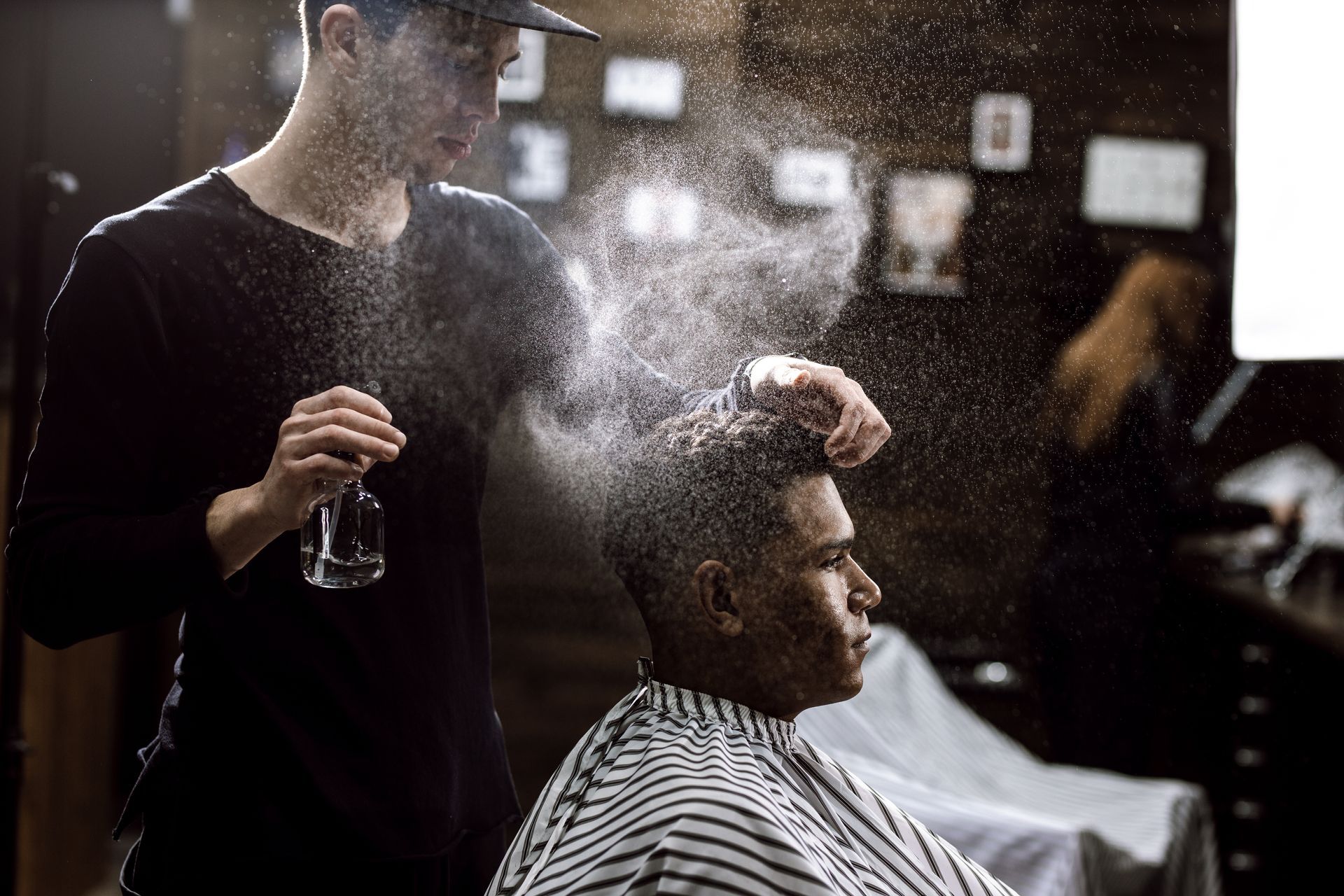 Barber Spraying Water on the Client's Hair