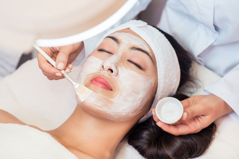 Therapist putting facial mask on a woman — Shepparton Skin & Body