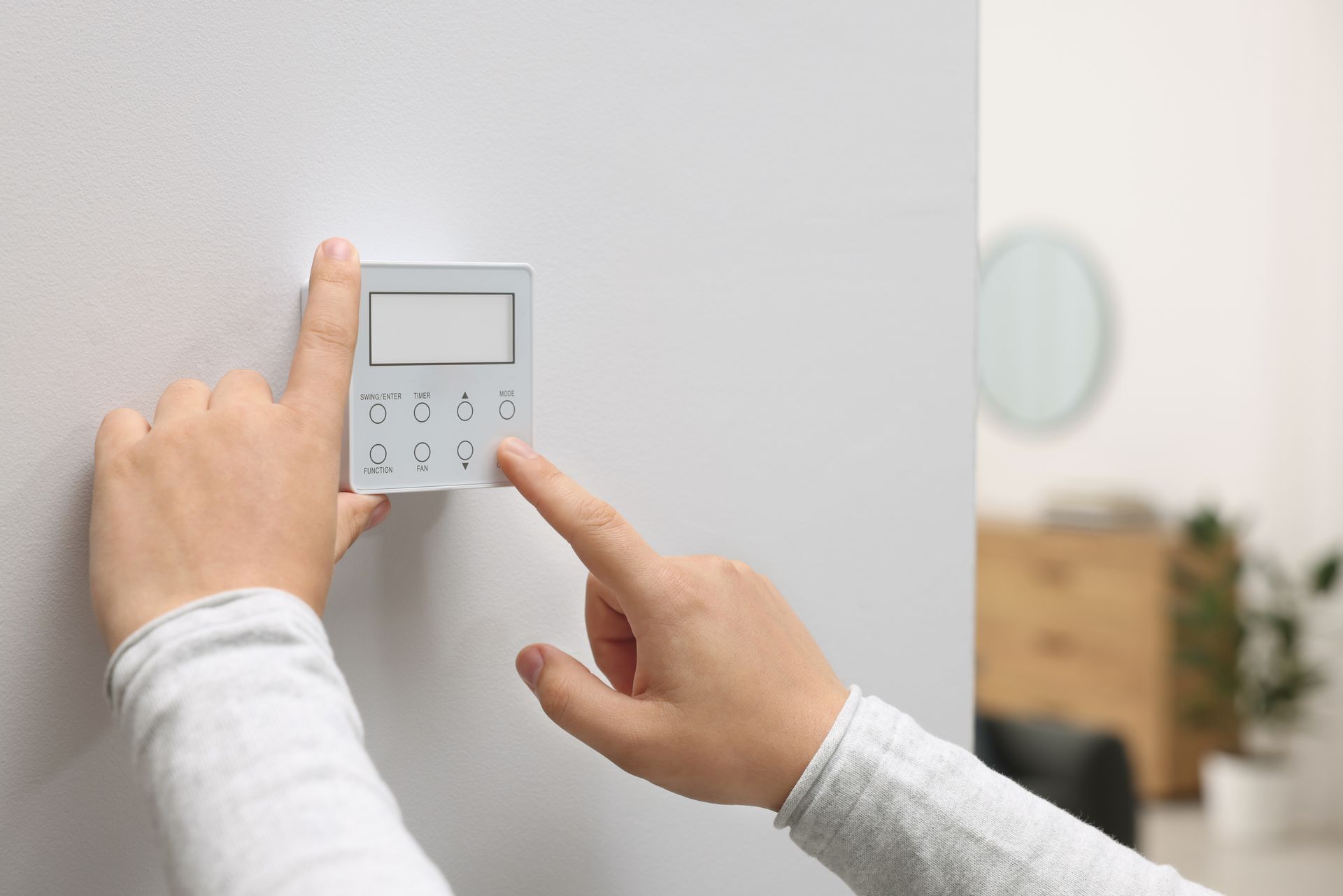 A person is pressing a button on a security system.