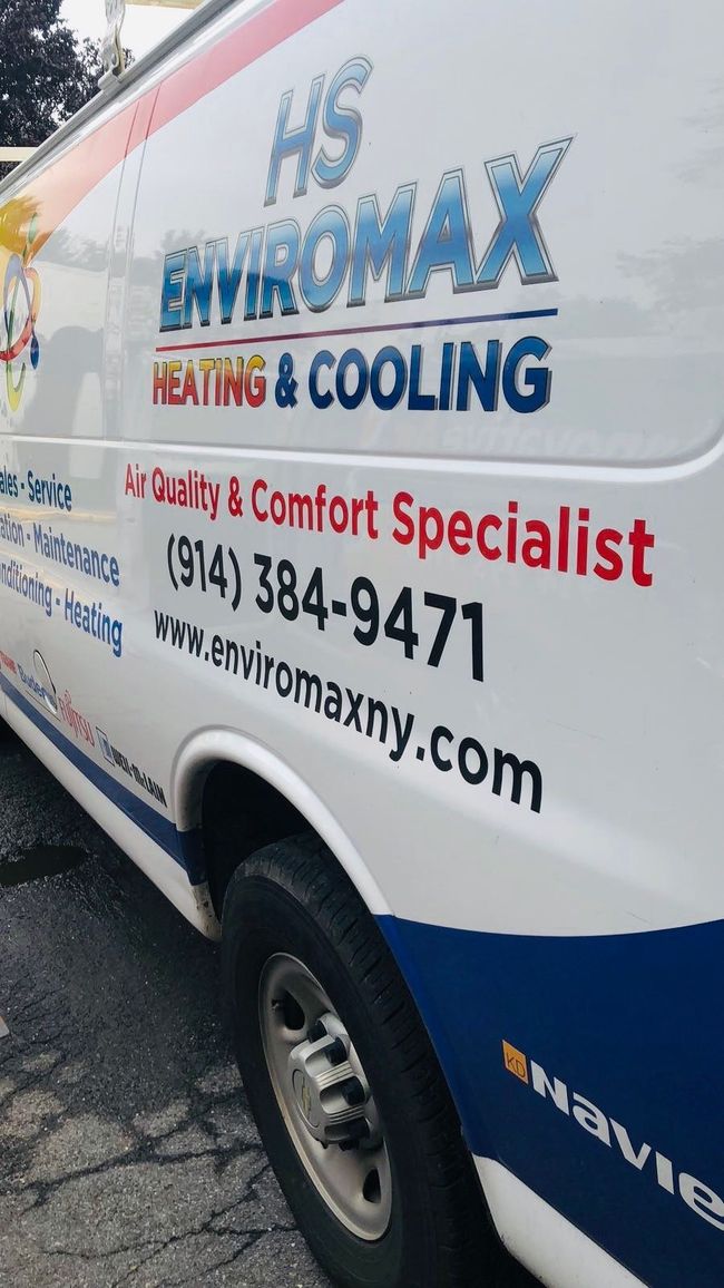 A hs enviromax heating and cooling van is parked on the side of the road.