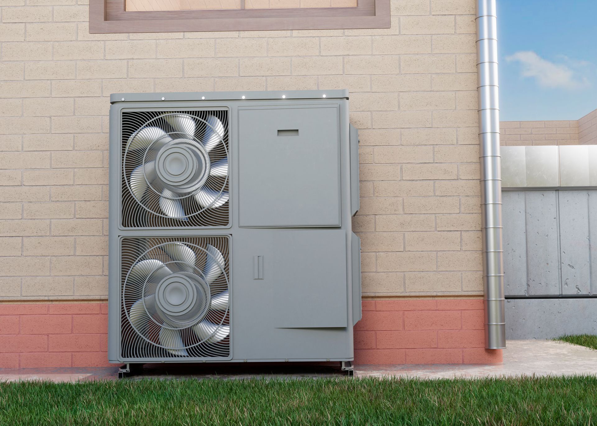 A large fan is sitting on the side of a brick building.