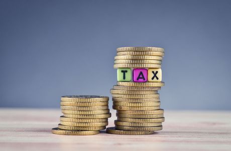 A stack of coins with the word tax written on them.