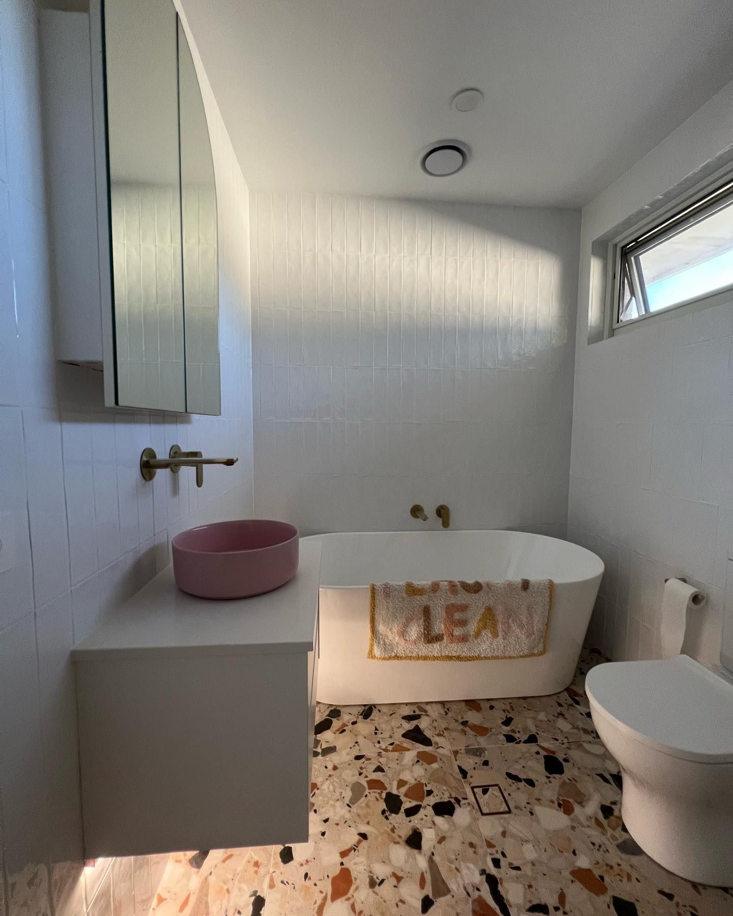 Modern Bathroom with A White Tub and Terrazzo Floor — J & H Plumbing and Gas in Holt, ACT