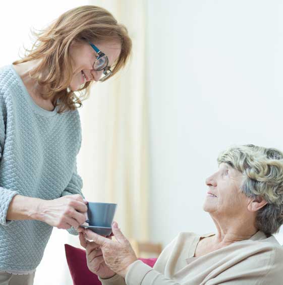 Care assistant helping elderly lady — Senior Care Facilities in Stewartville, MN