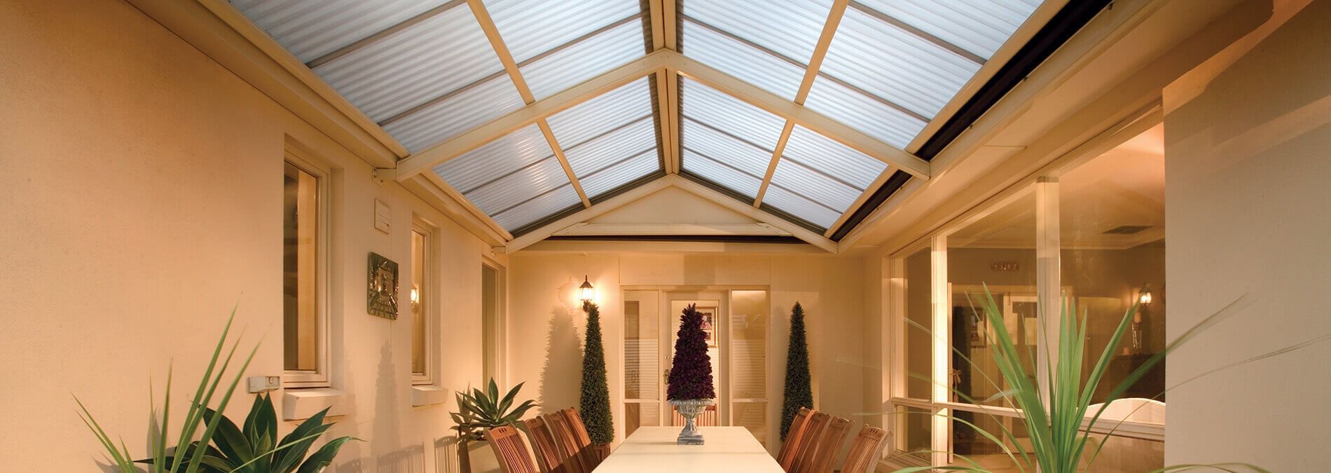 A large room with a table and chairs and a skylight.