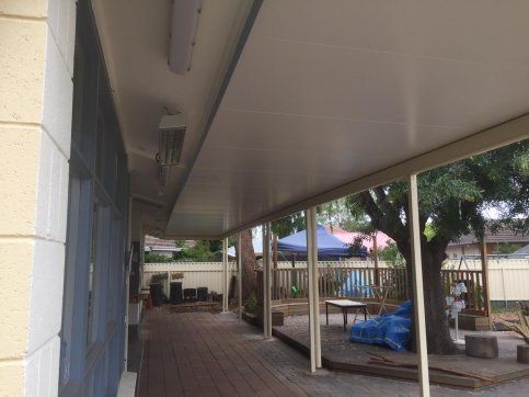 There is a covered walkway between two buildings.