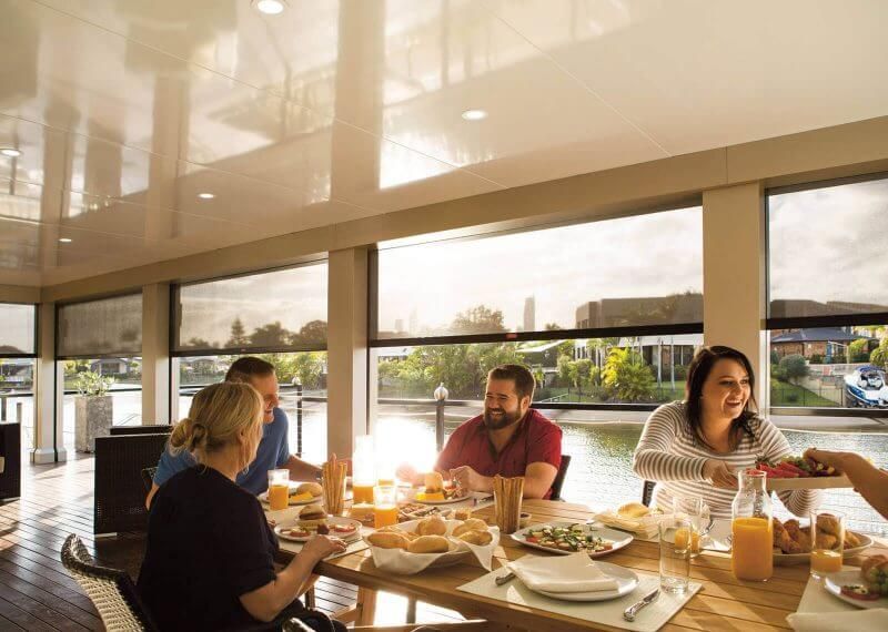 A group of people are sitting at a table eating food.