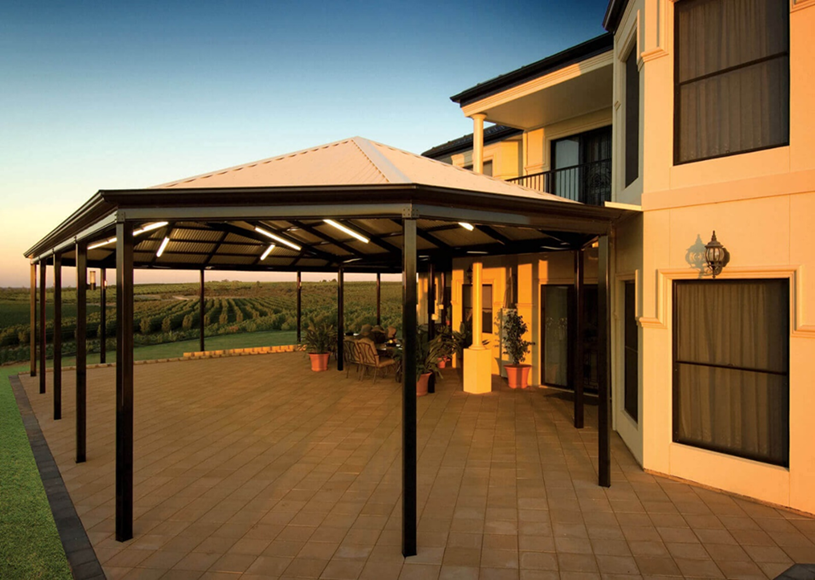 A large house with a covered patio in front of it