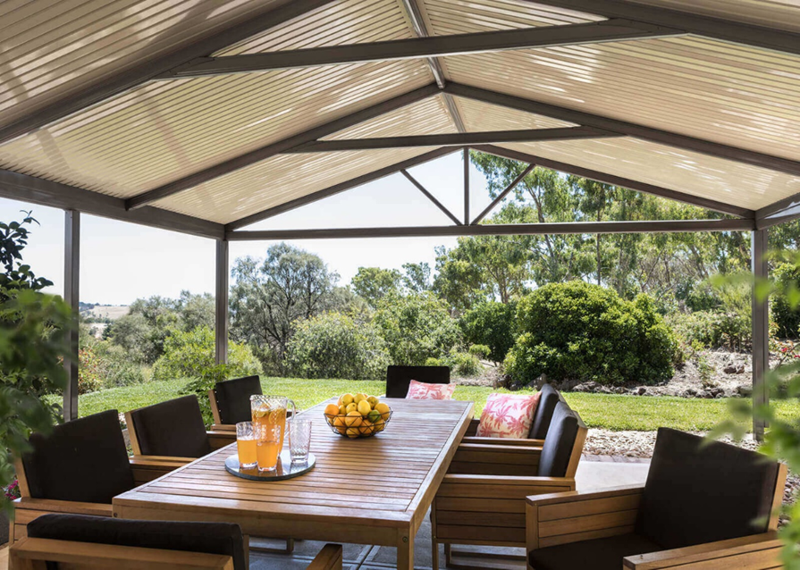 A patio with a table and chairs under a canopy.