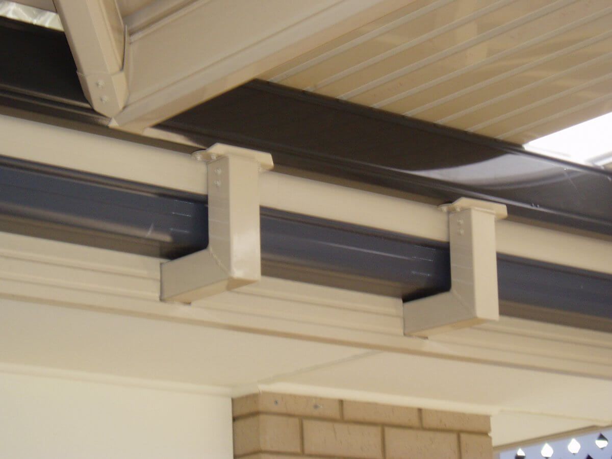 A close up of a gutter on the side of a building