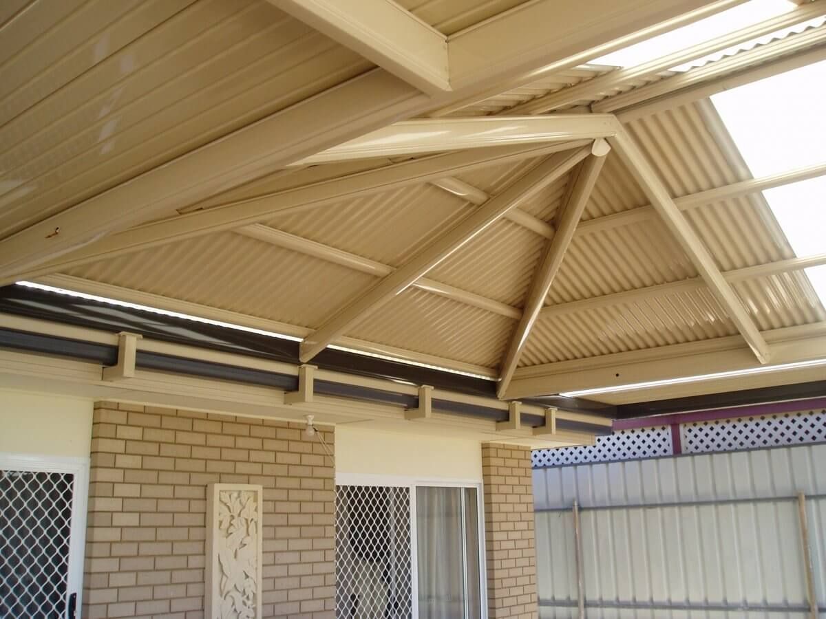 A brick house with a tan roof and a white door