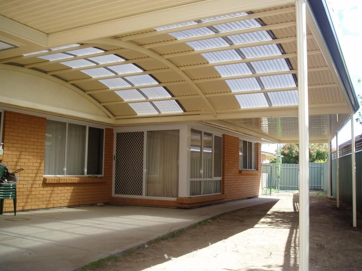 A brick house with a covered walkway leading to it
