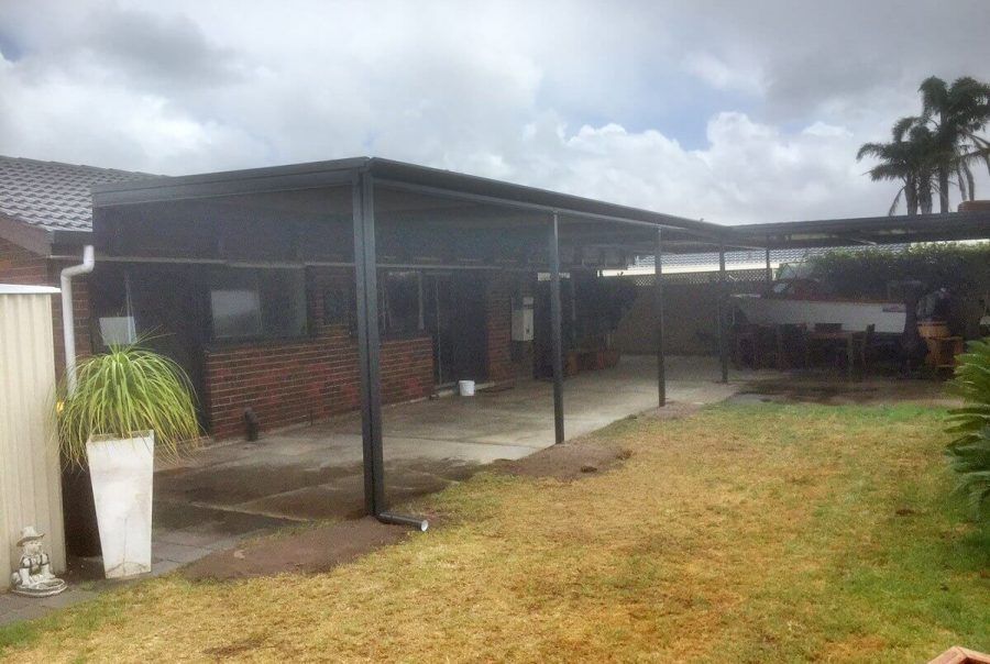 A house with a covered patio in the backyard.