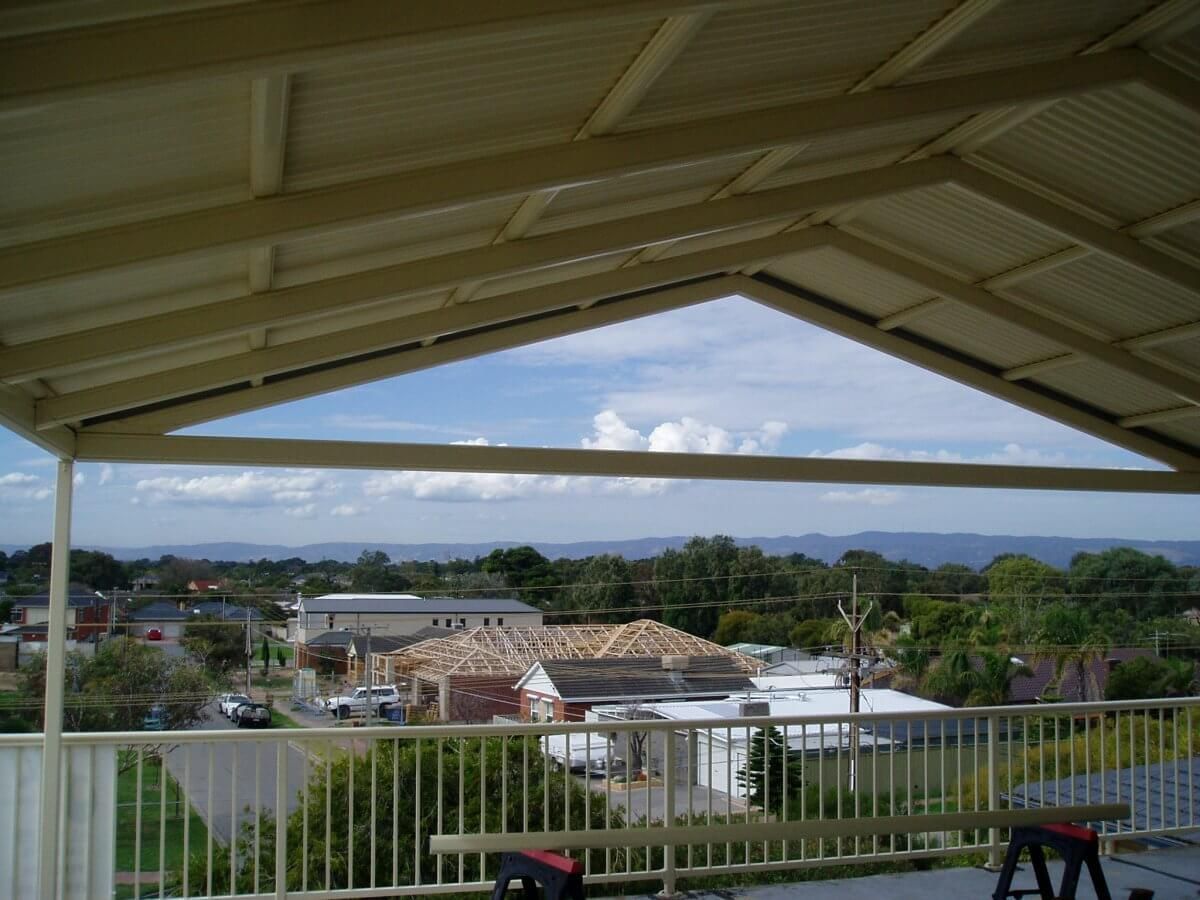 A balcony with a view of a city and mountains