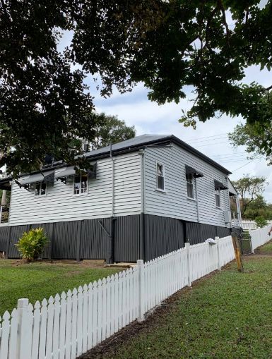A house with a white picket fence around it