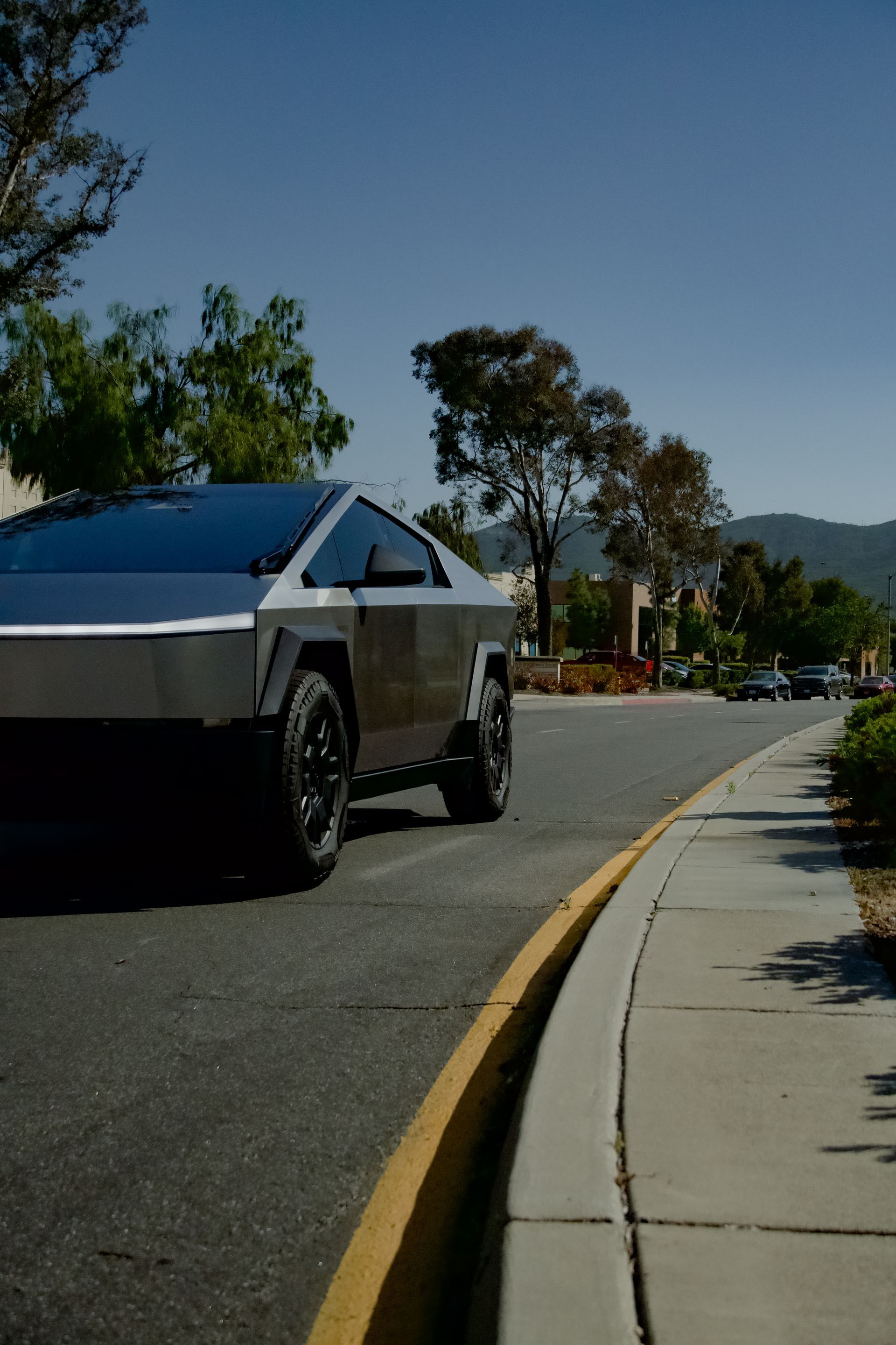 A tesla cybertruck is parked on the side of the road