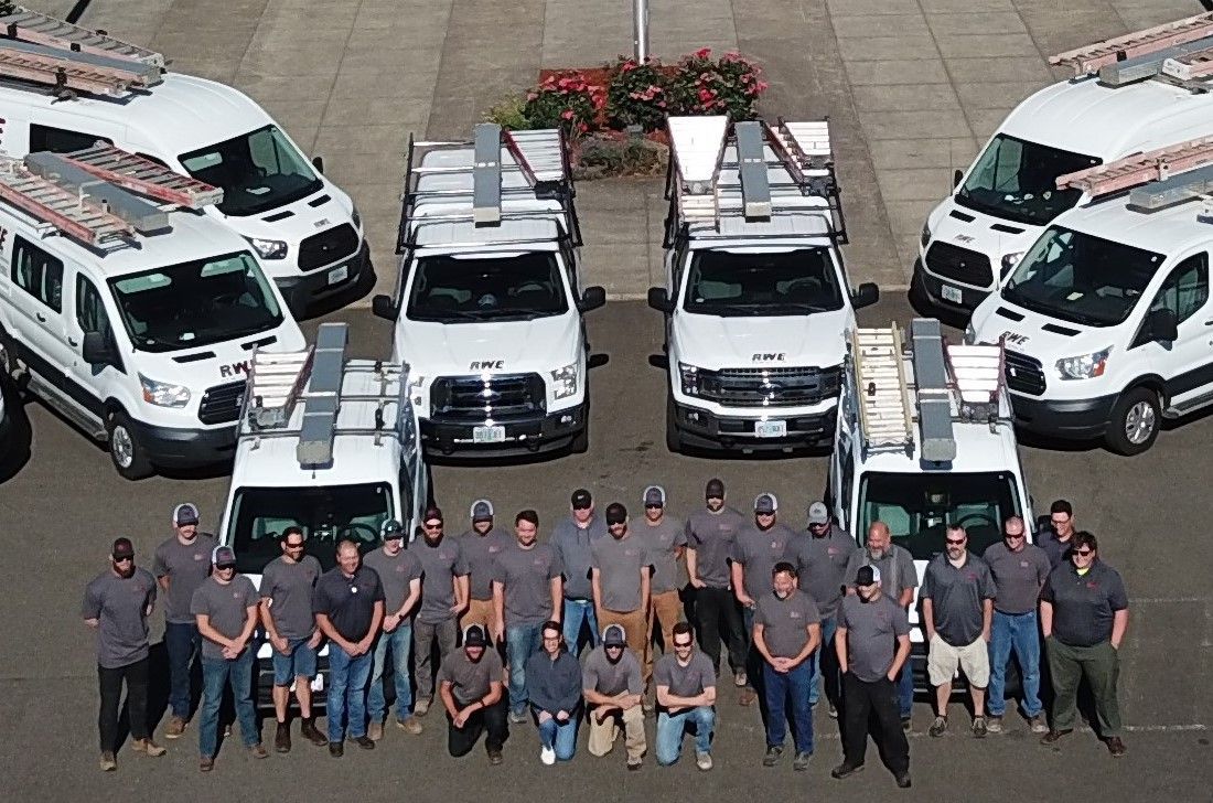 A group of people standing in front of a row of vans.