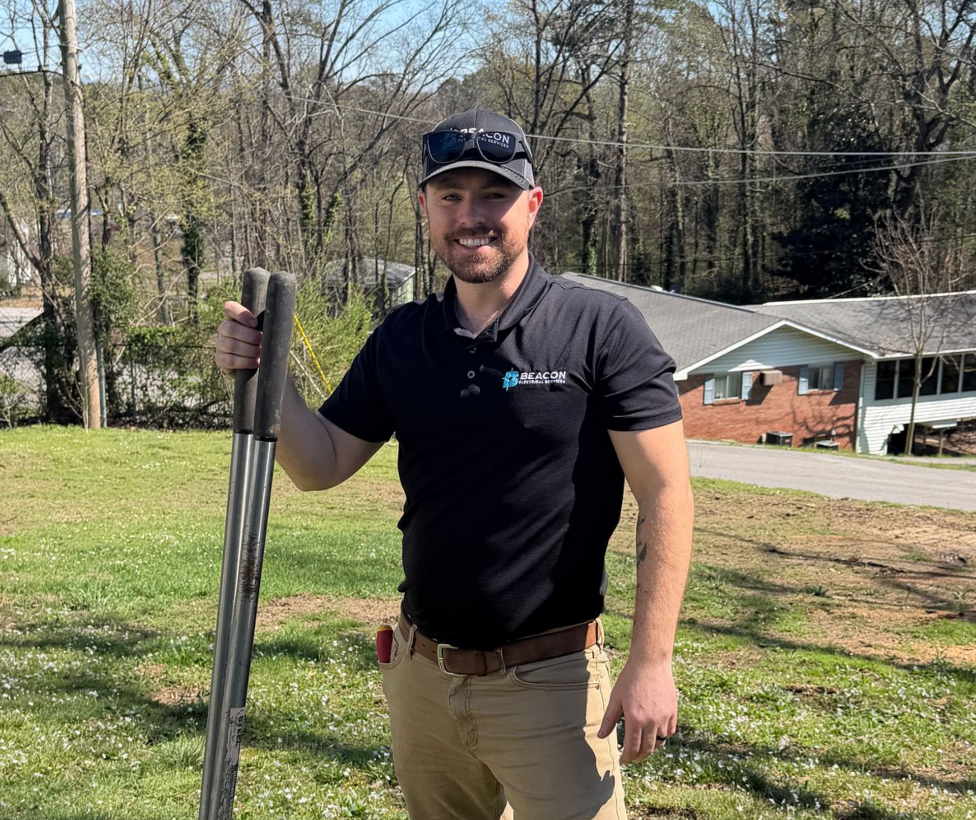 Person using a multimeter to test electrical wiring in a wall.