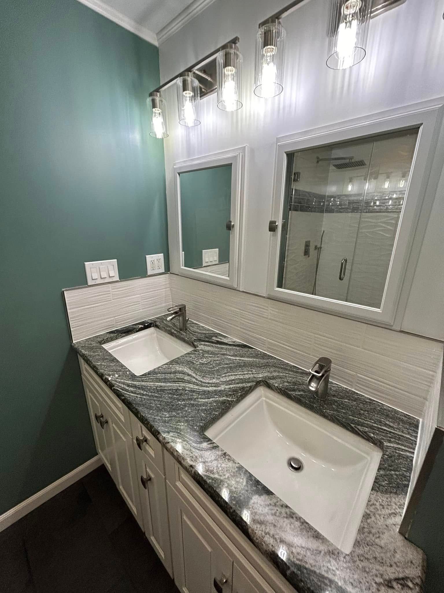 A bathroom with two sinks and two mirrors.