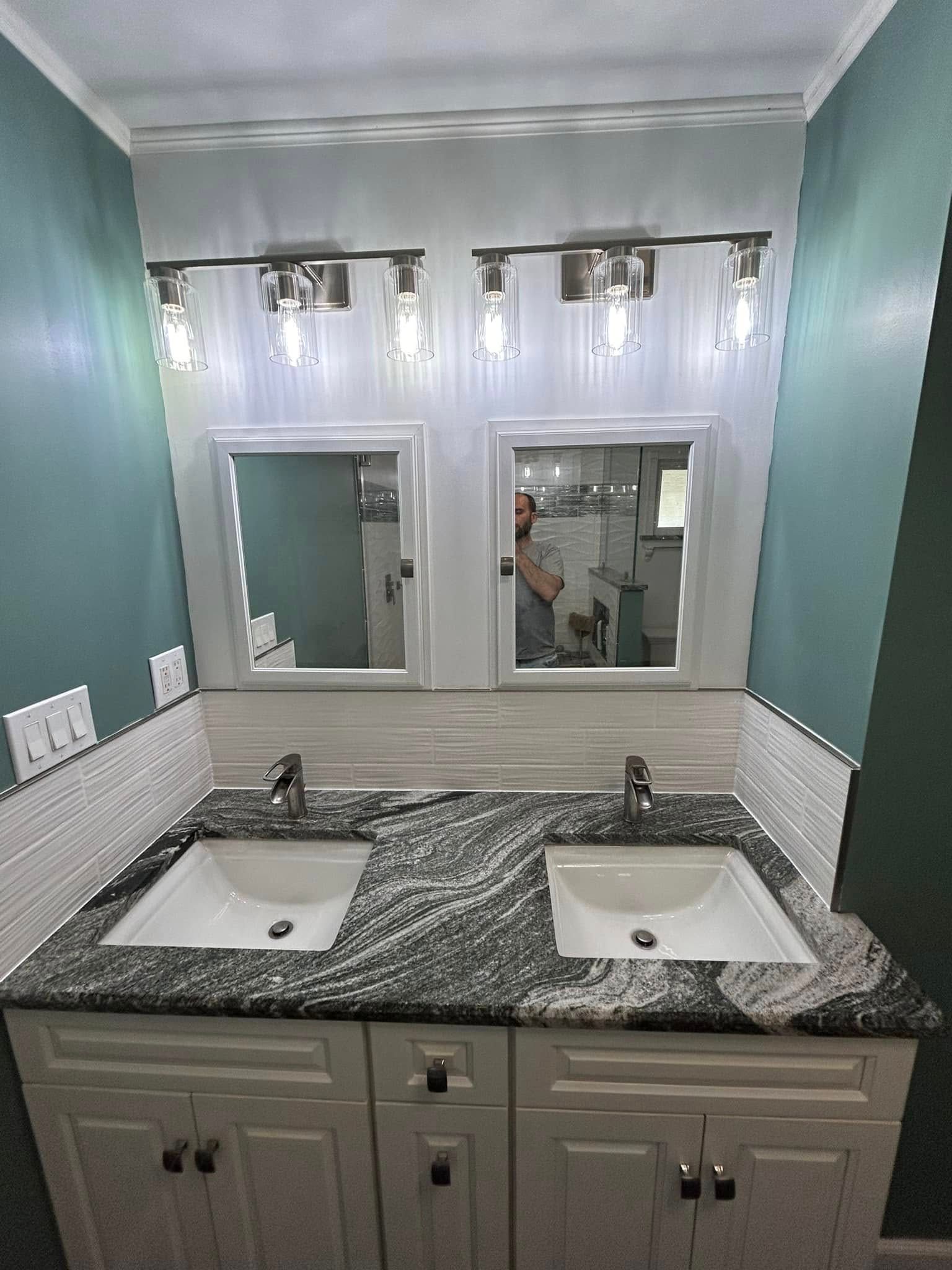 A bathroom with two sinks and two mirrors.