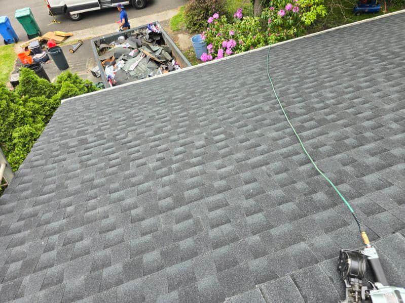 A roof with shingles being installed on a house.