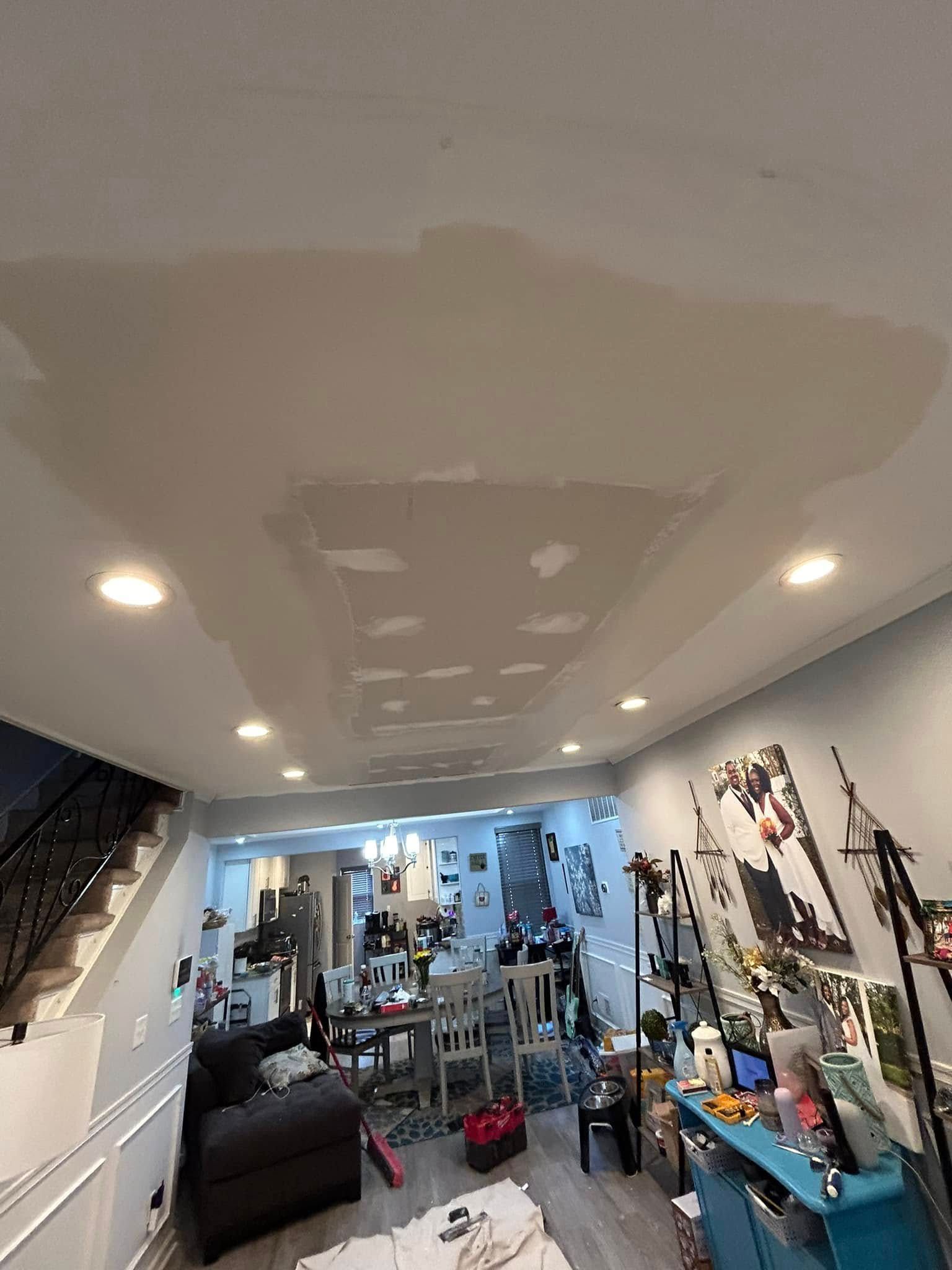 A living room with a ceiling that is being remodeled.