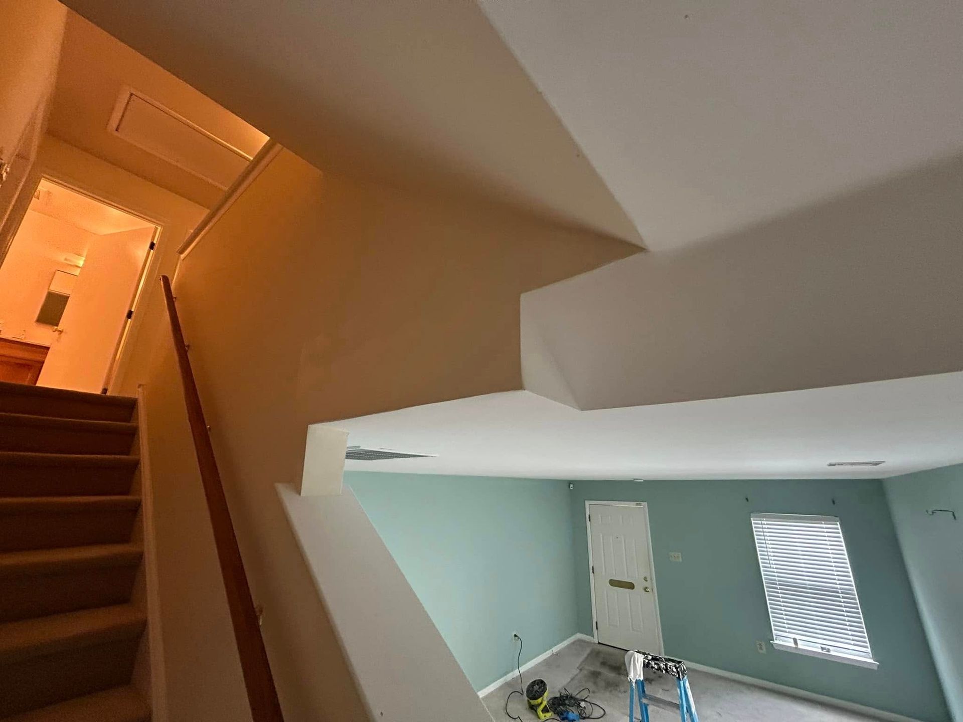 A room with stairs and a ladder in it