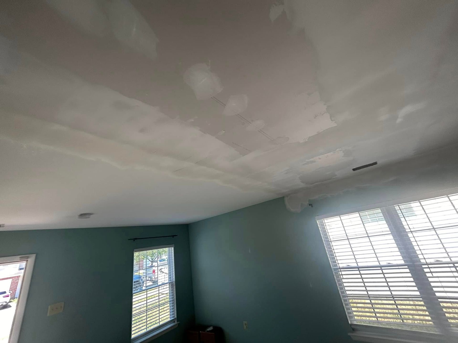 The ceiling of a room with a lot of windows and shutters.
