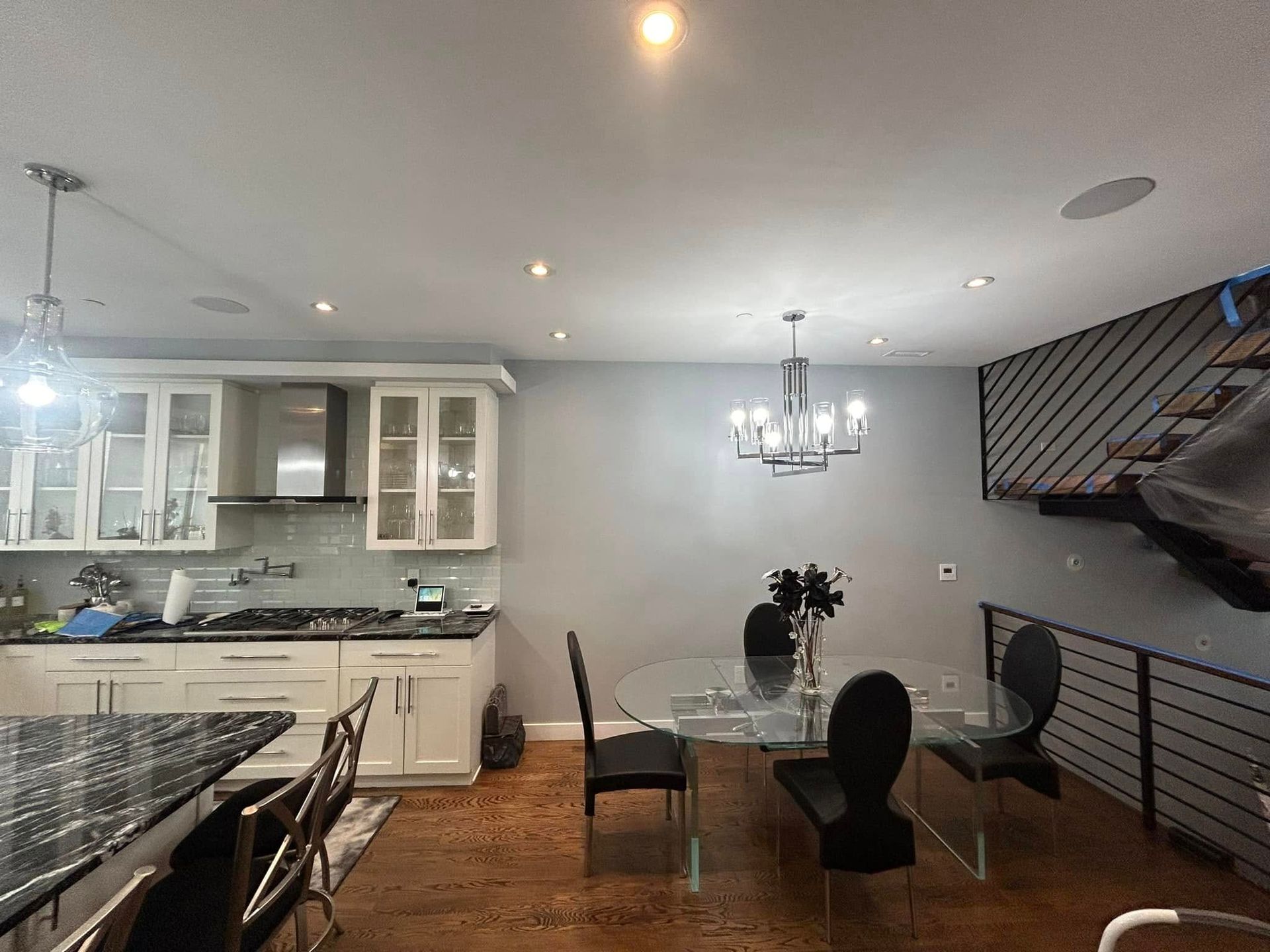 A kitchen and dining room with a glass table and chairs