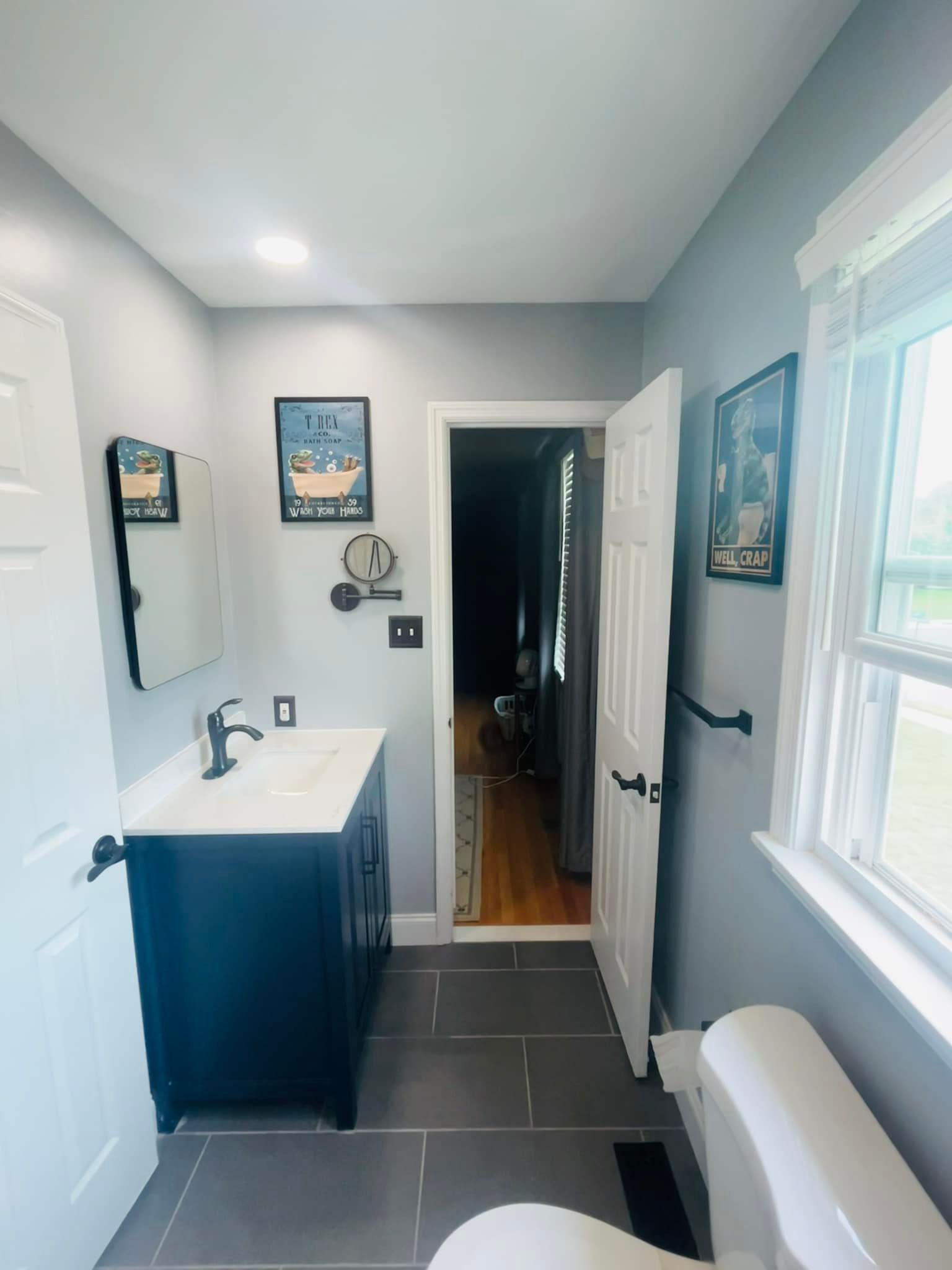 A bathroom with a sink , toilet and mirror
