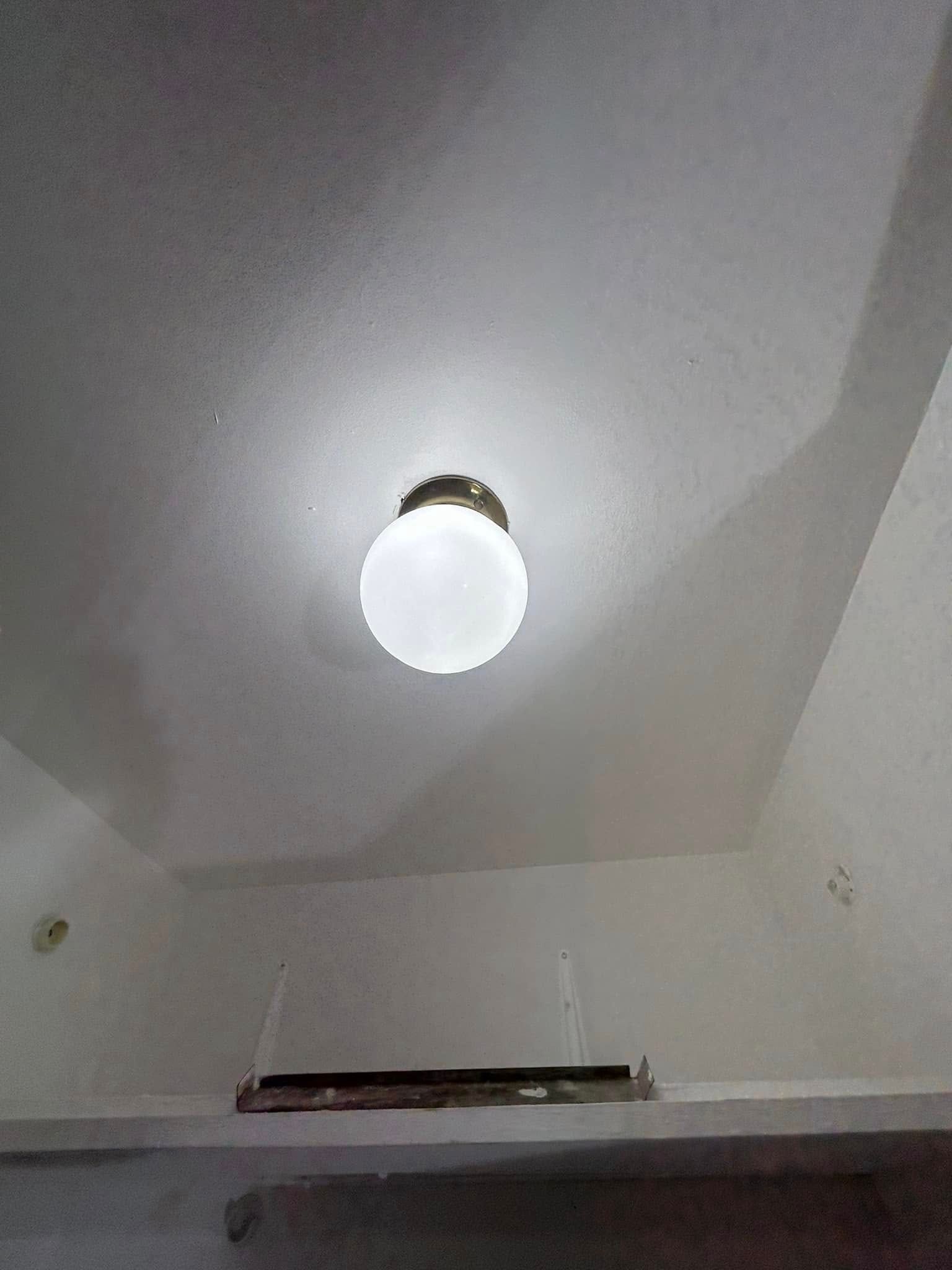 A light fixture is hanging from the ceiling of a kitchen.