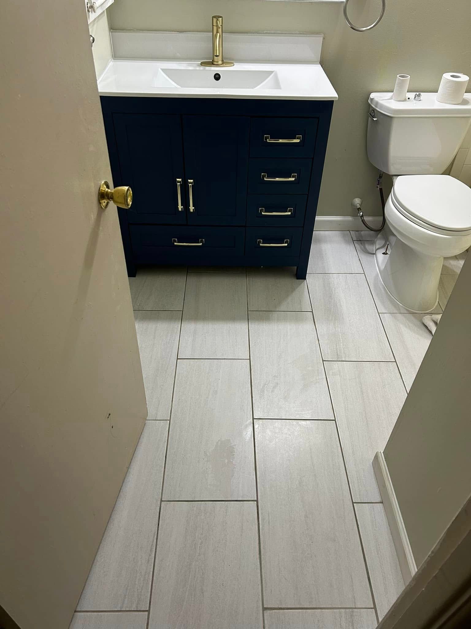A bathroom with a sink , toilet , and vanity.