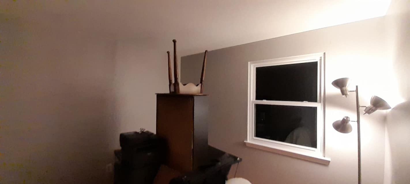 A living room with a lamp and a window.