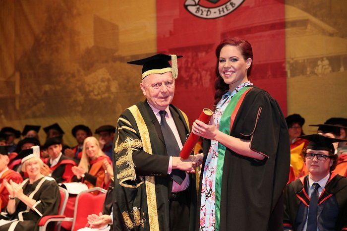 photo of Natasha Devon holding diploma