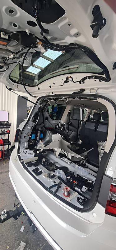 The Back Of A White SUV With The Trunk Open — Ballarat Auto Sparky in  Sebastopol, VIC