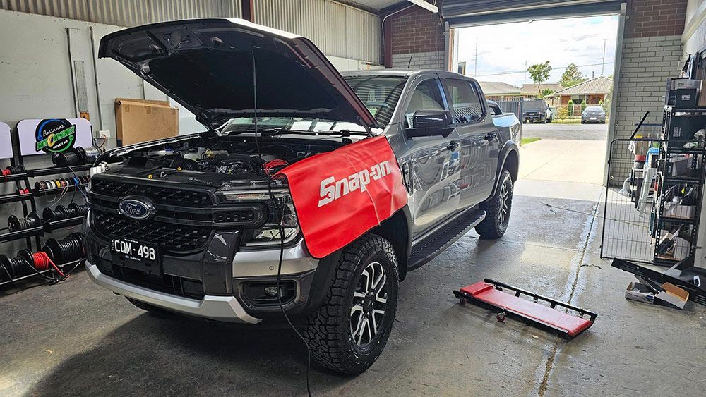 A Truck With The Hood Up Is Parked In A Garage — Ballarat Auto Sparky in  Sebastopol, VIC