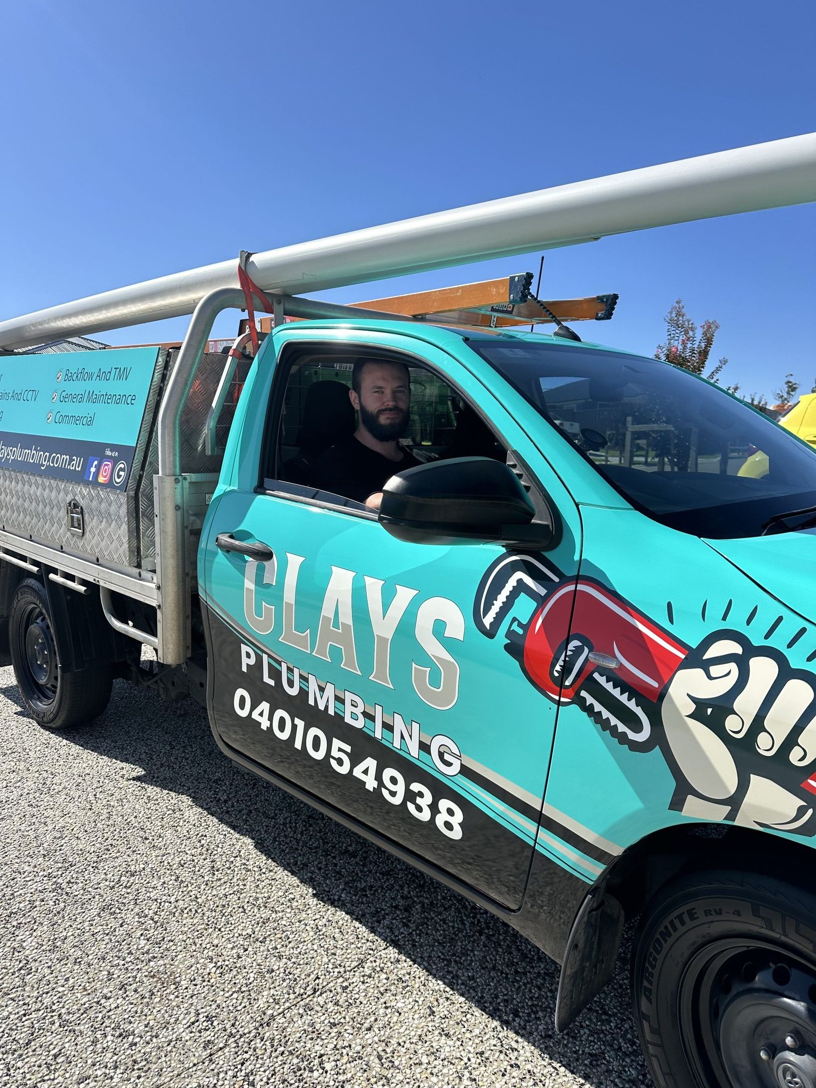 A teal plumbing truck with the name 