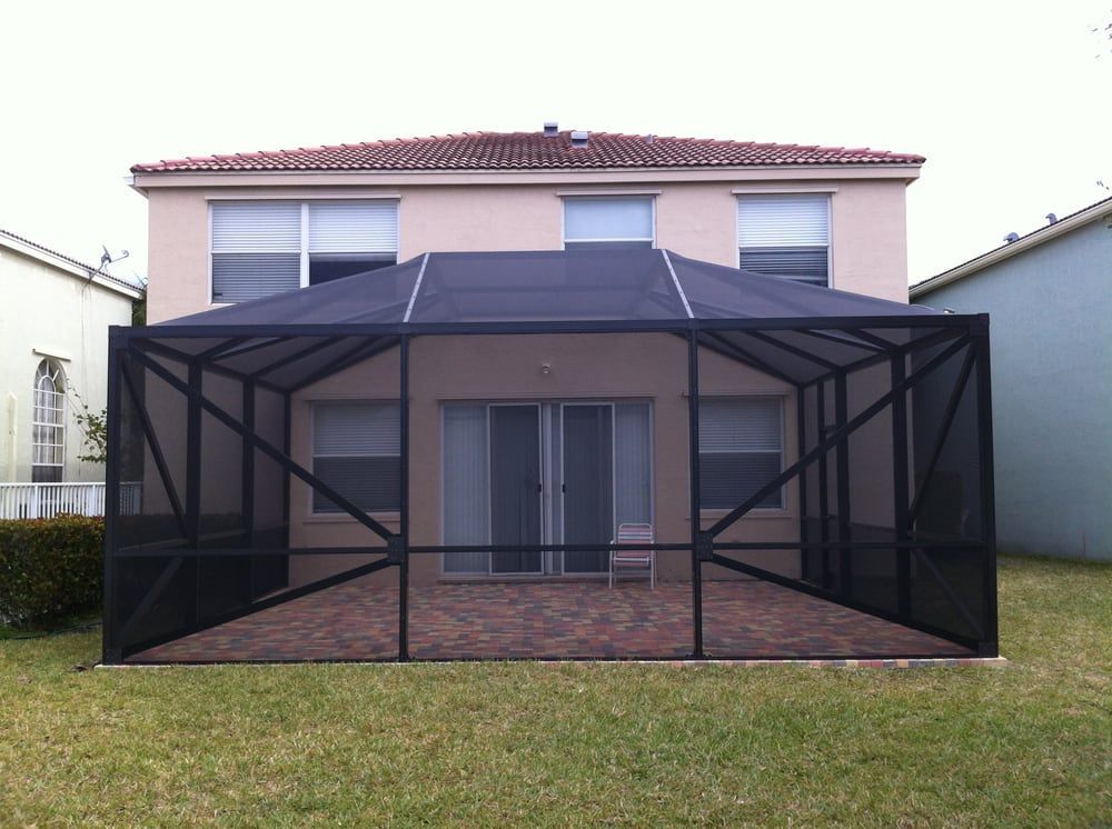 A house with a screened in patio in front of it