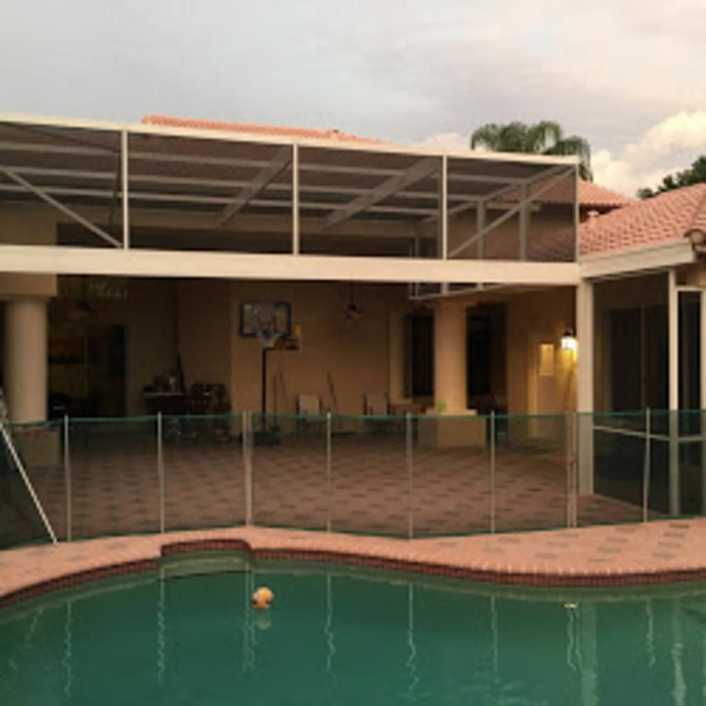 A large house with a swimming pool in front of it.