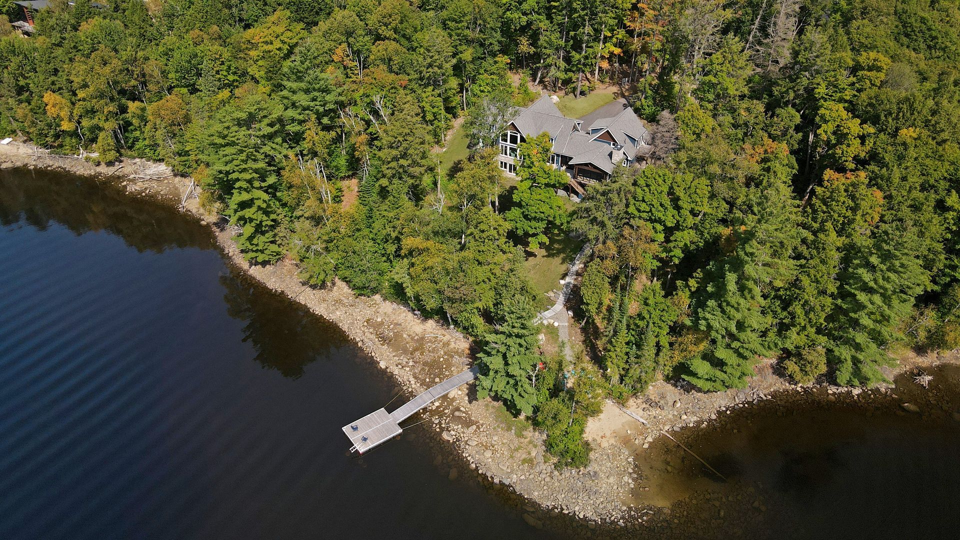 An aerial view of a large body of water surrounded by trees.