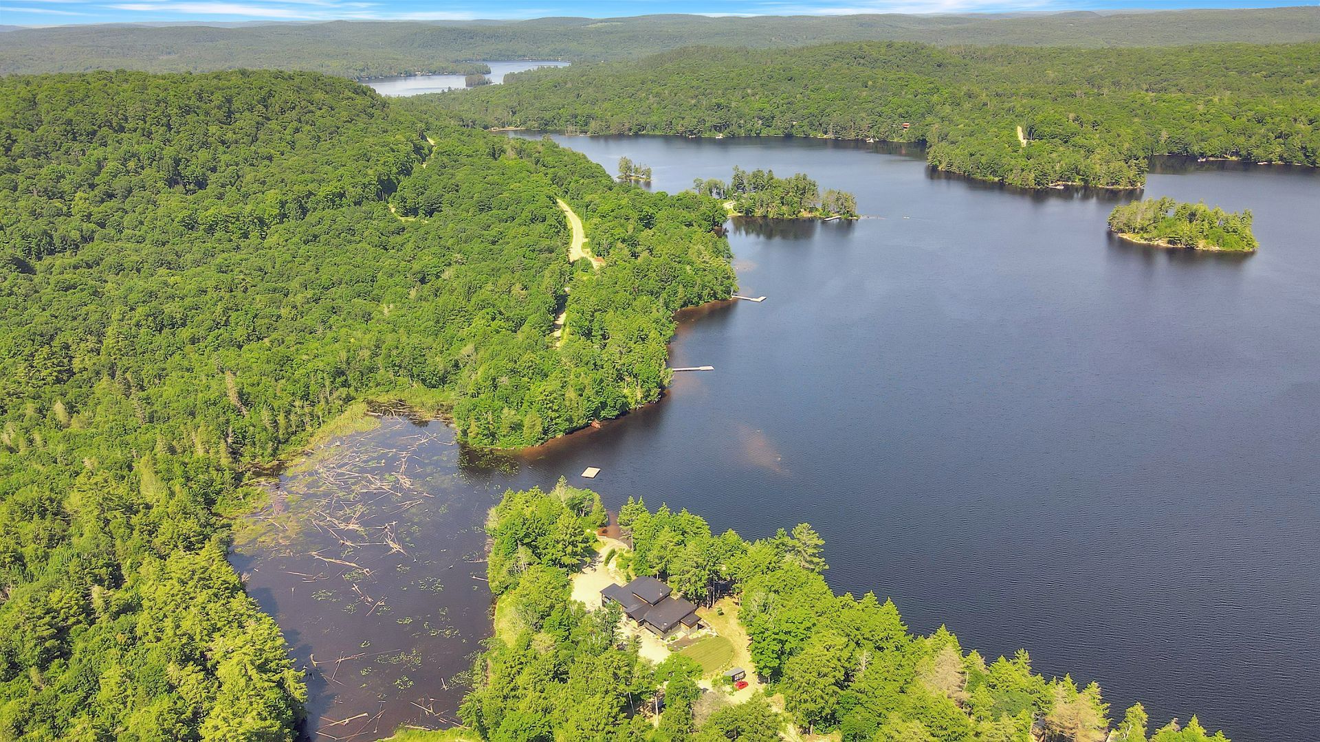 An aerial view of a large body of water surrounded by trees.